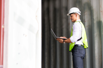 supervisor inspects wearing hardhat safety helmet working and checking control container shipping terminal at  shipping port for import and export