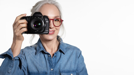 Smiling stylish senior woman with  digital camera portrait on white.  Tourism and hobby. 
