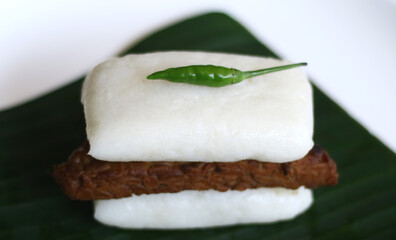 Jadah bacem on banan leaf. Jadah combined with tempe bacem. Indonesian food from yogyakarta.