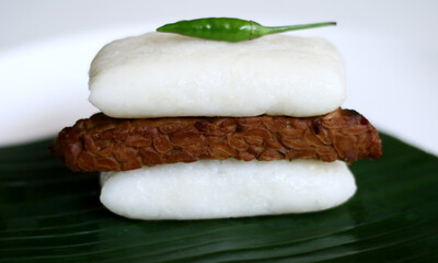Jadah bacem on banan leaf. Jadah combined with tempe bacem. Indonesian food from yogyakarta.