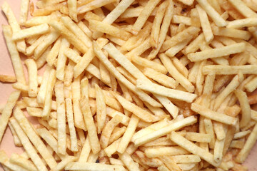Lots of french fries on a beige background