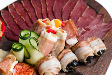 Assortment of cold meats, variety of processed cold meat products on a wooden board