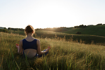 girl doing yoga in nature at sunset