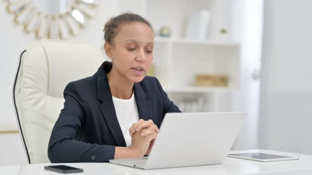 Professional African Businesswoman doing Video Call on Laptop in Office 