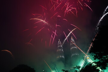 Kuala Lumpur, Malaysia – January 1, 2020: Colourful Fireworks spark during New Year at the Kuala Lumpur City. The image contains certain grain or noise and soft focus.