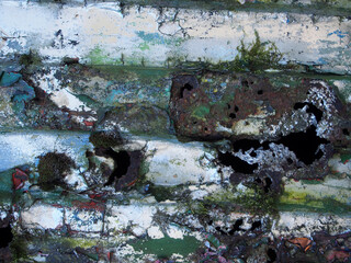 Fototapeta premium close up of an old rusted peeling steel with layers of peeling silver and green paint