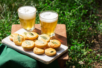 Salty shortbread cookies with sage and beer on a wooden stool.