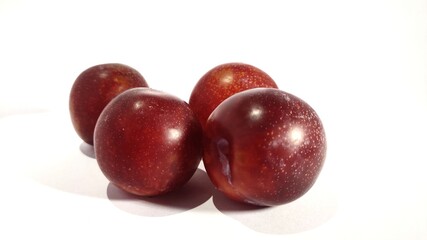 plums on white background