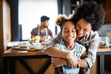 Happy family in the kitchen having fun and cooking together. Healthy food at home.