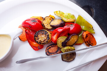 Fresh natural grilled vegetables with white sauce.