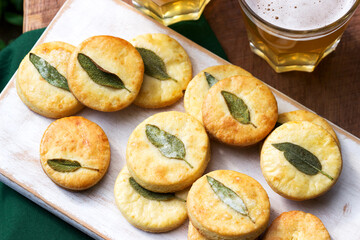 Salty shortbread cookies with sage and beer on a wooden stool.