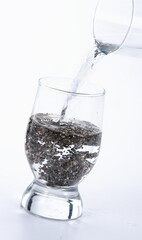 glass of water with chia seeds.