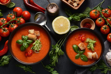 Andalusian gazpacho. Red tomato cold gazpacho soup in glass, with cucumber, onion, basil ,chili peppers and croutons.