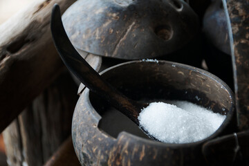 White sugar in a cup made from coconut shell