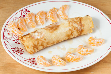 Tasty And Healthy Breakfast; Rolled Pancakes With Honey And Tangerine