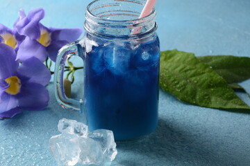 Iced butterfly pea latte. Healthy summer cold beverage, iced organic blue and violet butterfly pea flower tea 