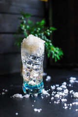 cocktail with ice and liquor
blue curacao
food background top view copy space for text