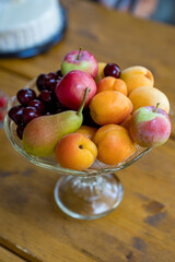 glass vase with summer fruit.
