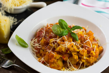 Paella with chicken breast, red pepper and cocktail tomatoes.