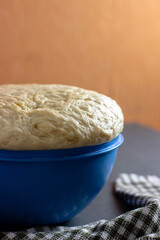 yeast dough for pie in a bowl on the table