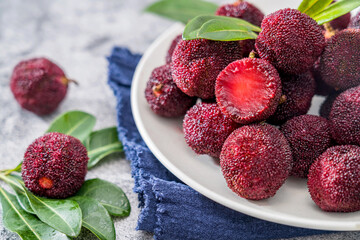  bowl of bayberry placed on a concrete table