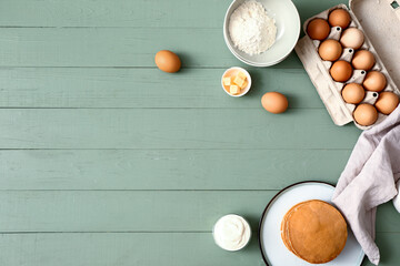 Tasty pancakes with ingredients on table