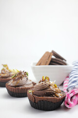 Homemade choco tart or mufins served with whipped cream,chocolate and dryfruits.