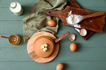 Tasty pancakes with ingredients on table