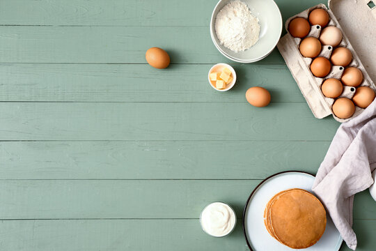 Tasty pancakes with ingredients on table