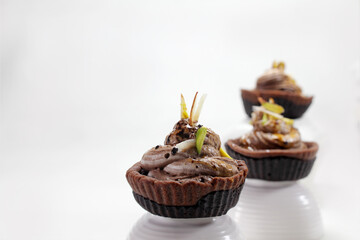 Homemade choco tart or mufins served with whipped cream,chocolate and dryfruits.