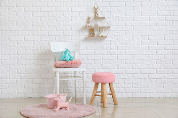 Chair with baskets and kid toys in room