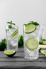 Glasses of fresh mojito on table