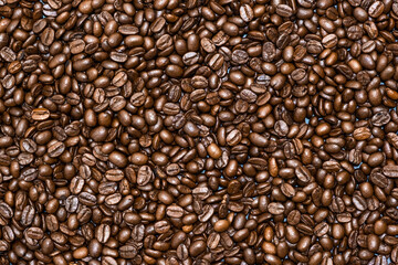 Top view of brown roasted coffee beans, can be use as background, copy space for text.