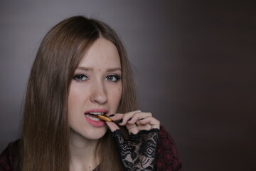 Beautiful young woman with black cat ears on the head