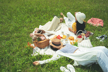 Asian woman friends, they are resting and are having a picnic.