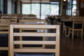 Fototapeta na wymiar Wood table top on blur empty restaurant interior background.