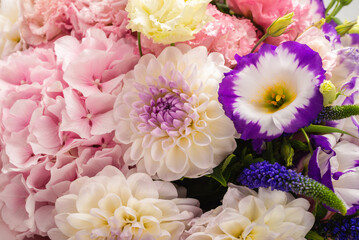 Pink and purple bouquet of flowers in a pink box isolated on white.