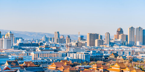 Dazhao Temple in Hohhot, Inner Mongolia, China and the distant view of tall buildings in the distance