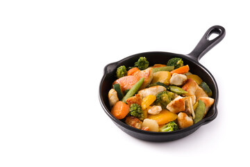 Stir fry chicken with vegetables on iron pan isolated on white background. Copy space