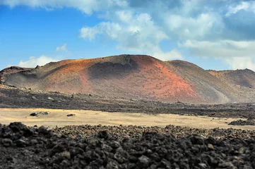 Foto op Canvas lava wall and volcano at Timanfaya National Park, Lanzarote Island, Canary Islands, Spain © andreslebedev