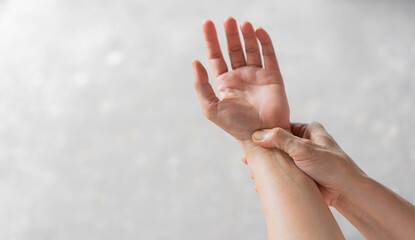 close up senior woman massage on hand to relief pain from hard working for treatment about carpal...