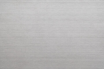 Silver metal texture of brushed stainless steel plate with the reflection of light.