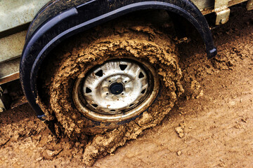 Dirty wheel of a car trailer. Traveling by car in places without roads