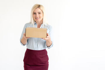 Fototapeta premium A young beautiful caucasian woman holding a box in her hands.