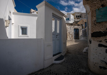 Courtyards of the white city of Santorini under the bright sun. Greece