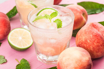 Summer cold alcohol beverage, iced peach Bellini cocktail with mint leaves,
