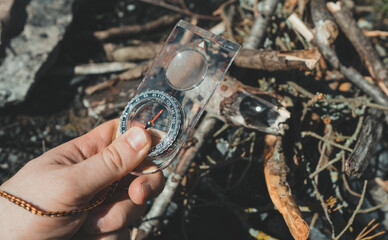 Man uses a magnifying glass to burn a bonfire.