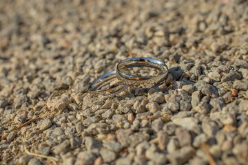 Wedding silver rings on gravel