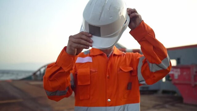 Filipino deck Officer on deck of vessel or ship , wearing PPE personal protective equipment.