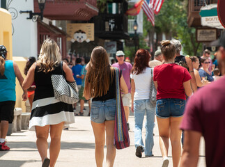 A group of women walk through historic St. Augustine, Florida on a humid summer day. 